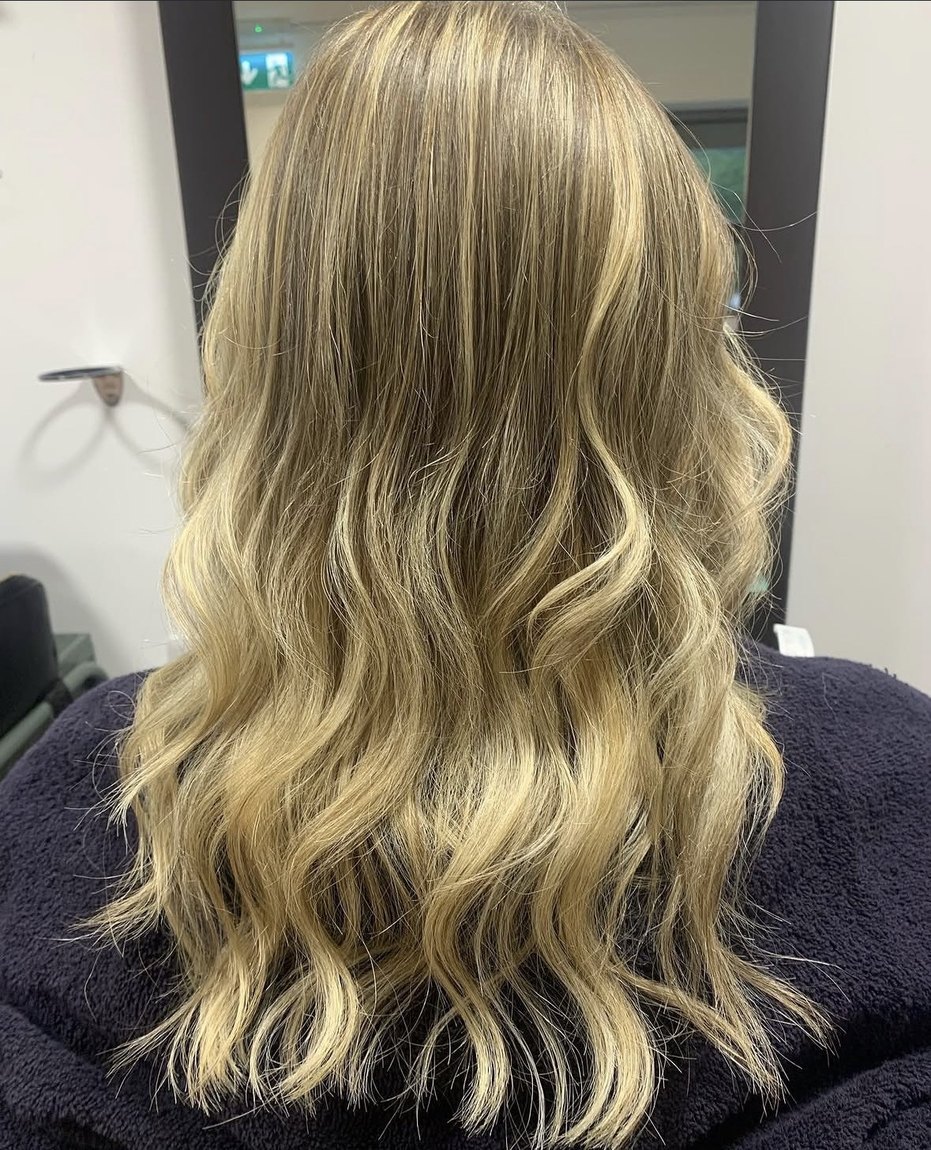 Glossy, healthy blonde waves after colour and a treatment at INCH Hair Design