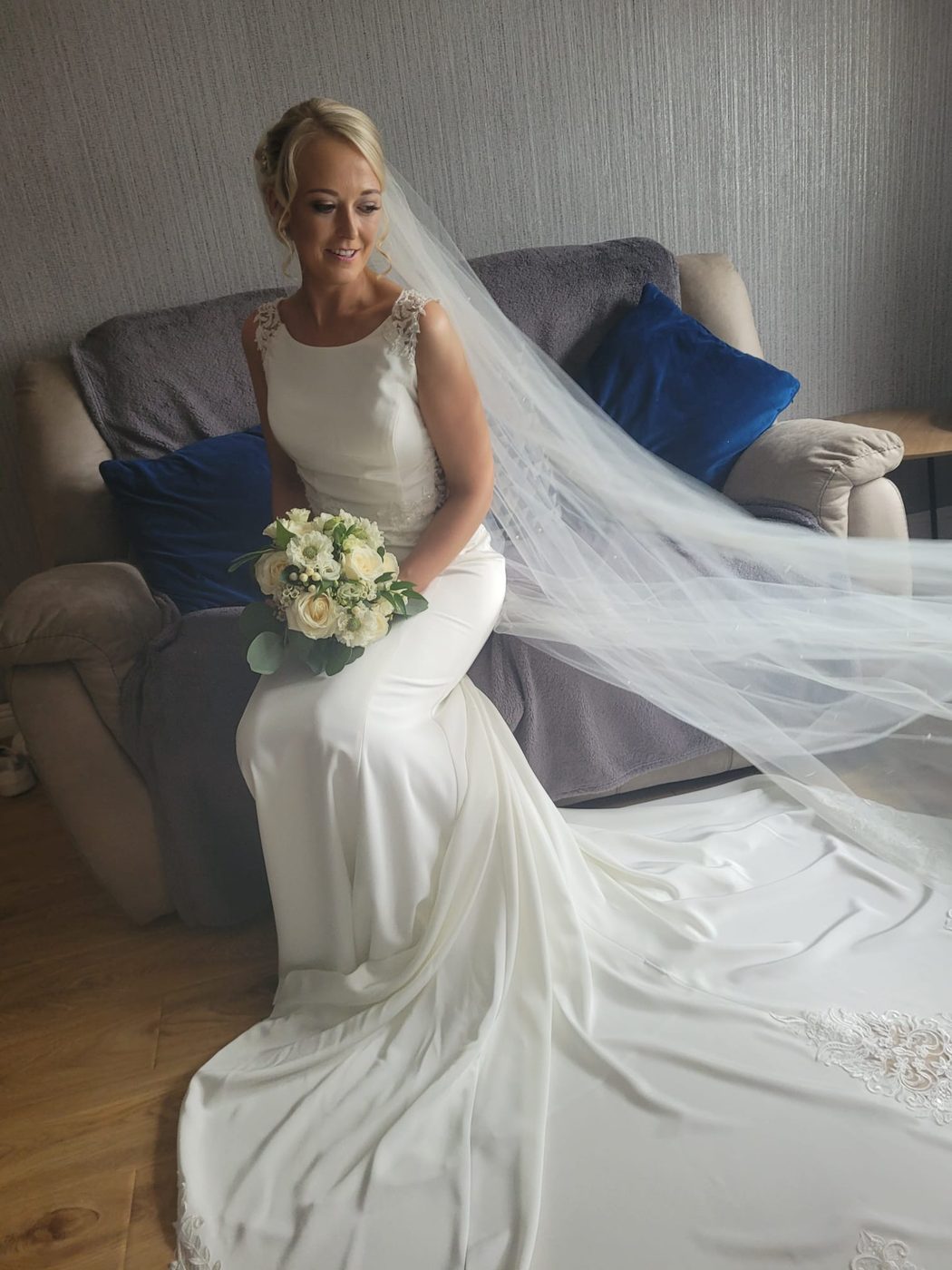Bride with a sleek style and full-length veil, styled at INCH Hair Design