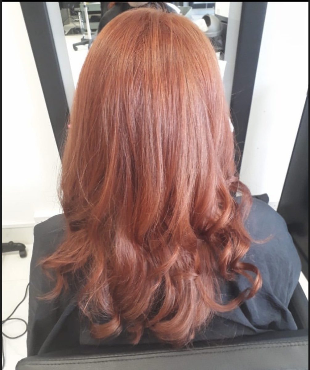 Rich copper colour with soft curls at INCH Hair Design