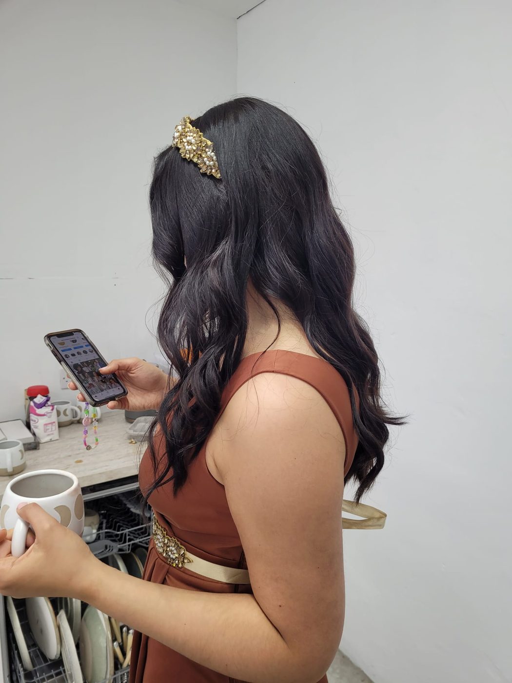 Dark waves dressed with a gold hair clip at INCH Hair Design