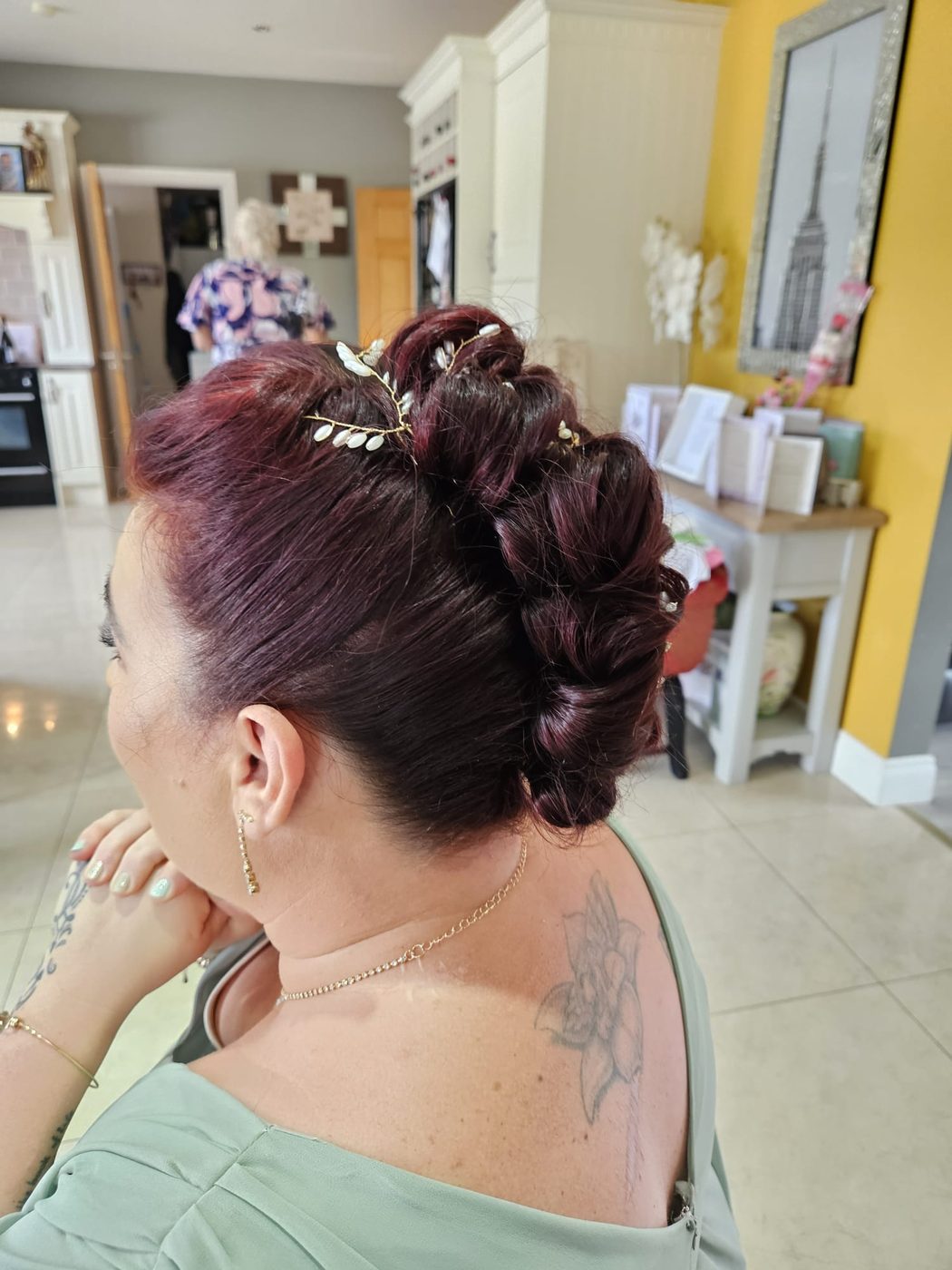 An intricate deep-red occasion updo at INCH Hair Design